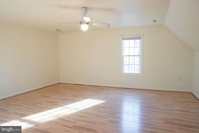 interior space with vaulted ceiling, ceiling fan, and light wood-type flooring