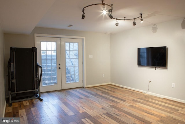 entryway featuring hardwood / wood-style floors, track lighting, and french doors