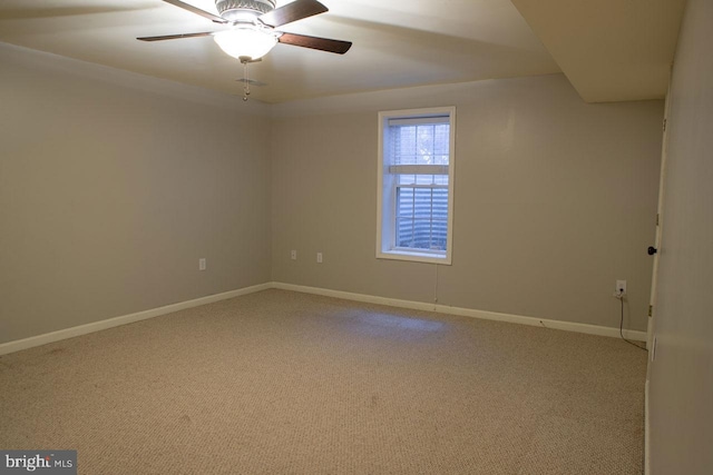 carpeted spare room with ceiling fan