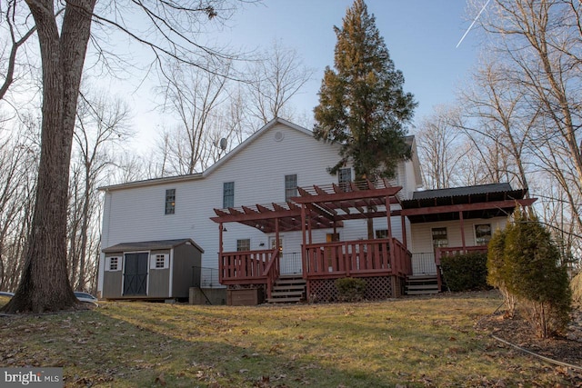 back of house featuring a shed, a yard, a pergola, and a deck