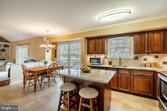 kitchen featuring a sink, decorative backsplash, plenty of natural light, and appliances with stainless steel finishes