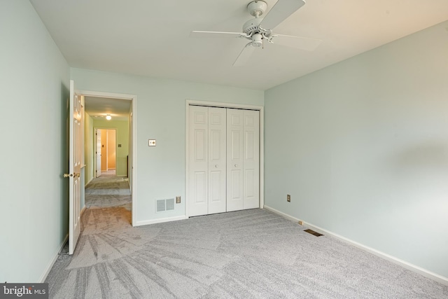 unfurnished bedroom with a closet, baseboards, visible vents, and carpet floors