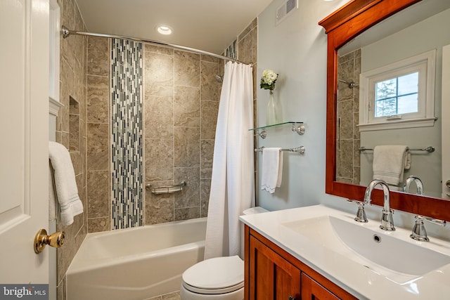 bathroom featuring visible vents, vanity, toilet, and shower / tub combo with curtain