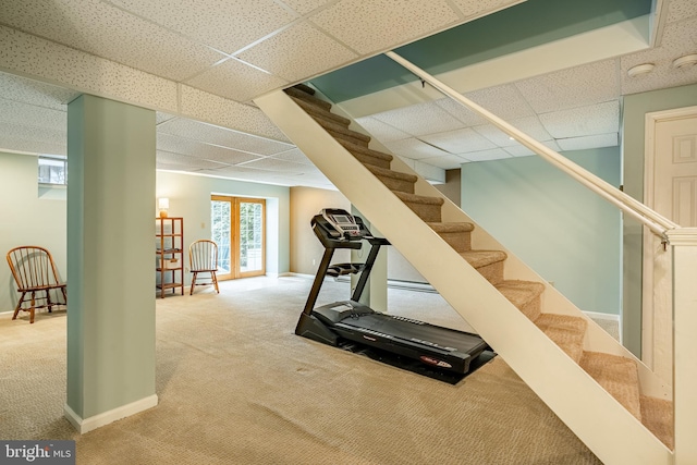 workout room with baseboards and carpet floors