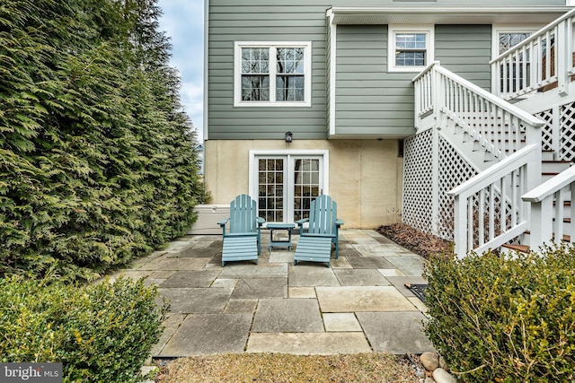 back of property with a patio, stairway, and stucco siding