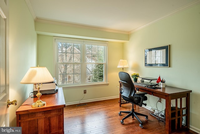 office area with visible vents, crown molding, baseboards, and wood-type flooring