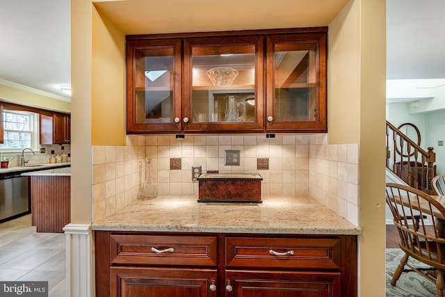 bar featuring backsplash, crown molding, stairway, stainless steel dishwasher, and a sink