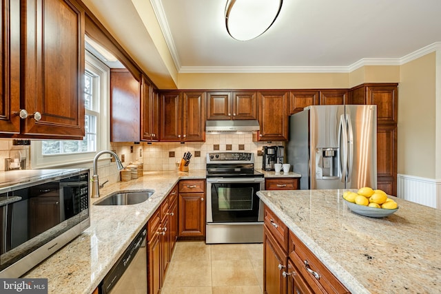 kitchen with under cabinet range hood, backsplash, appliances with stainless steel finishes, and a sink