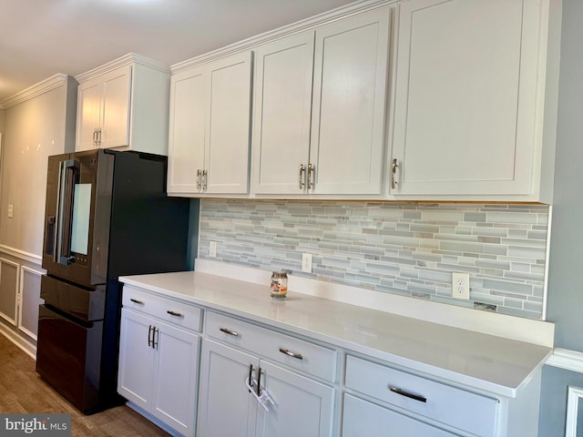 kitchen with white cabinets, decorative backsplash, dark wood-style flooring, fridge with ice dispenser, and light countertops