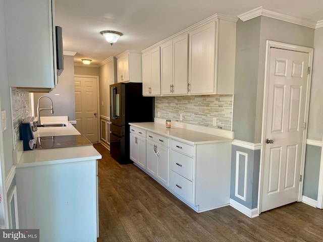 kitchen with ornamental molding, dark wood-type flooring, and freestanding refrigerator