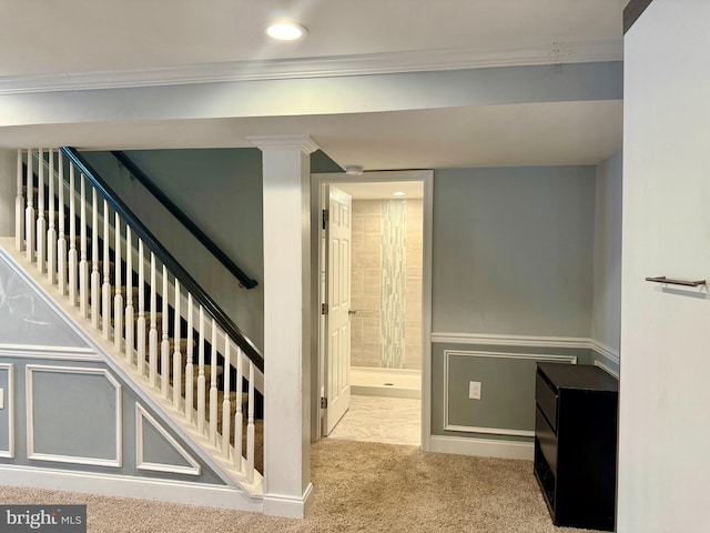 stairway with carpet floors, recessed lighting, crown molding, and a decorative wall