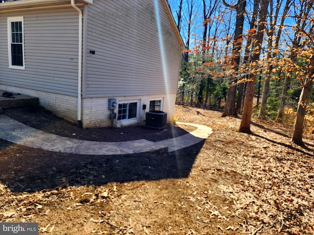 view of side of property featuring central air condition unit