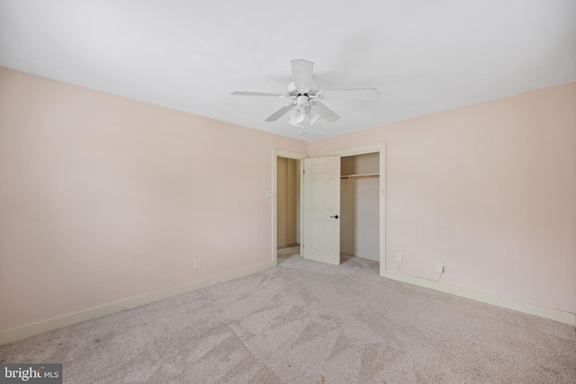 unfurnished bedroom featuring ceiling fan, light colored carpet, and a closet