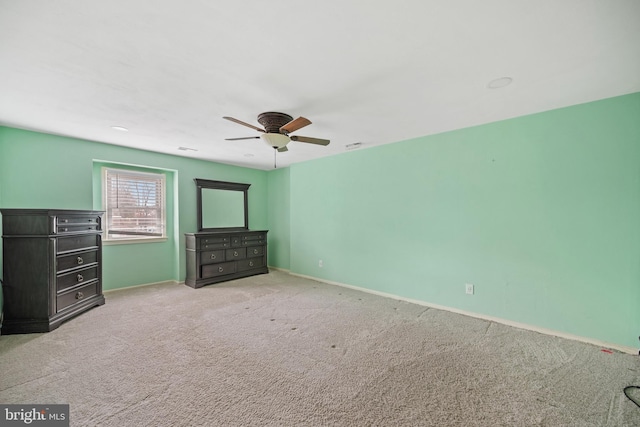 unfurnished bedroom with light carpet and ceiling fan