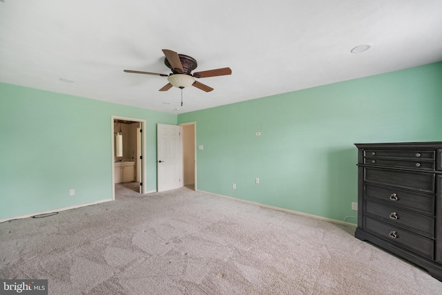 unfurnished bedroom with light colored carpet, ceiling fan, and ensuite bathroom