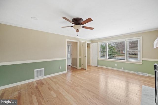 spare room with ornamental molding, light hardwood / wood-style floors, and ceiling fan