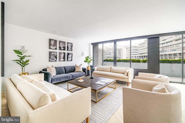 living room with expansive windows and light hardwood / wood-style flooring