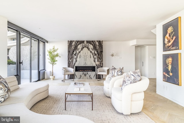 living room with a fireplace and light parquet flooring