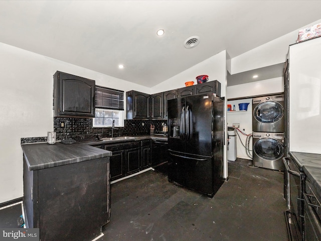 kitchen featuring a sink, black fridge with ice dispenser, visible vents, stacked washer / drying machine, and dark countertops