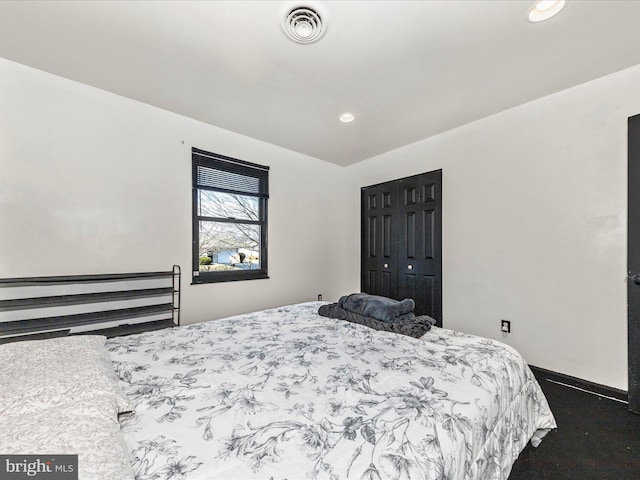 bedroom with a closet, recessed lighting, visible vents, and baseboards