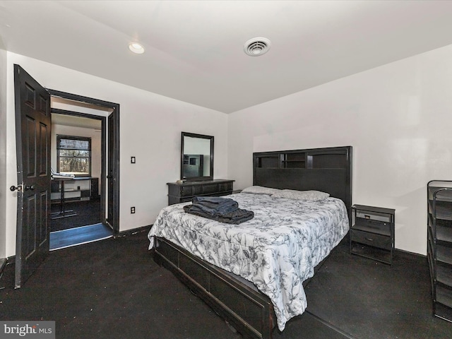 bedroom featuring baseboards and visible vents