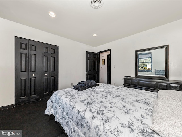 bedroom with visible vents, dark colored carpet, a closet, and recessed lighting