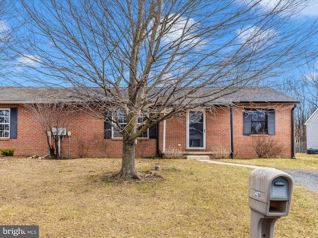 single story home with a front lawn and brick siding