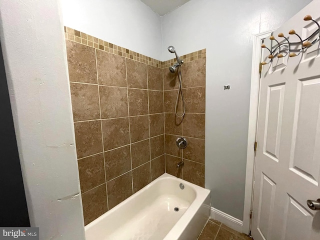 bathroom with tiled shower / bath combo and tile patterned flooring