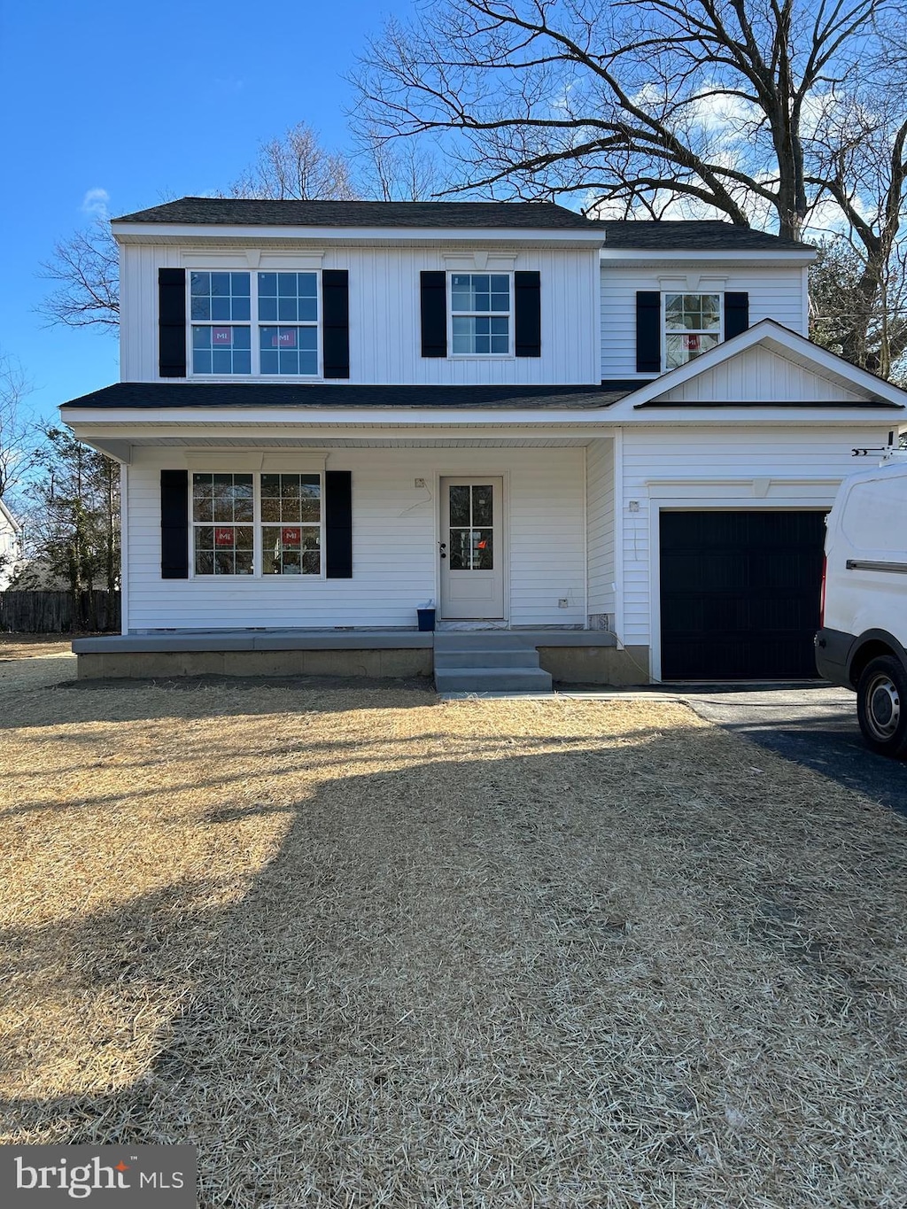 front facade featuring a garage and covered porch