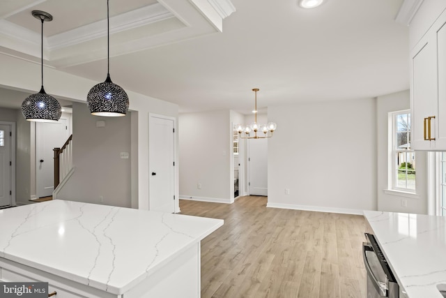 kitchen featuring light stone counters, decorative light fixtures, light hardwood / wood-style flooring, and a center island