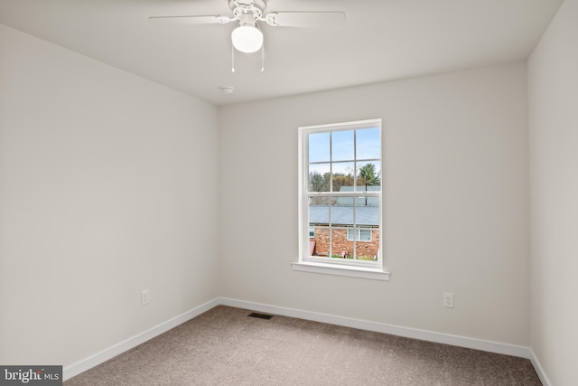 empty room with ceiling fan and carpet floors