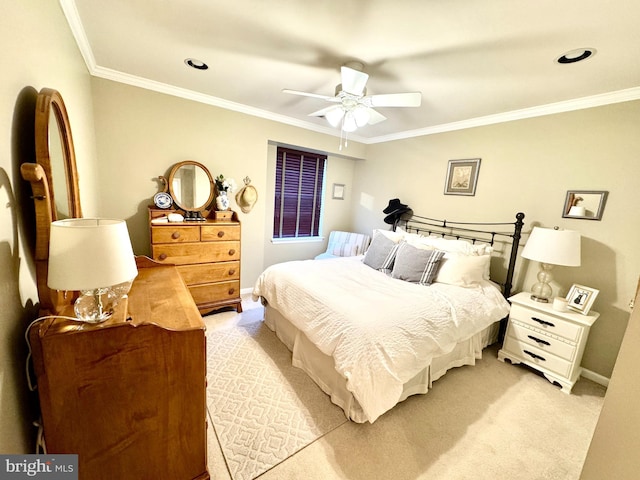 bedroom featuring crown molding, light colored carpet, and ceiling fan