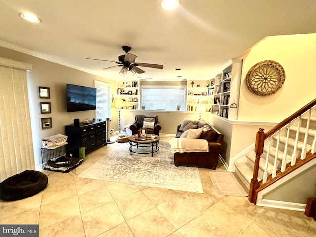 living room featuring ceiling fan, ornamental molding, and tile patterned floors