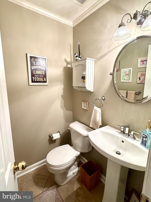 bathroom with crown molding, tile patterned floors, and toilet