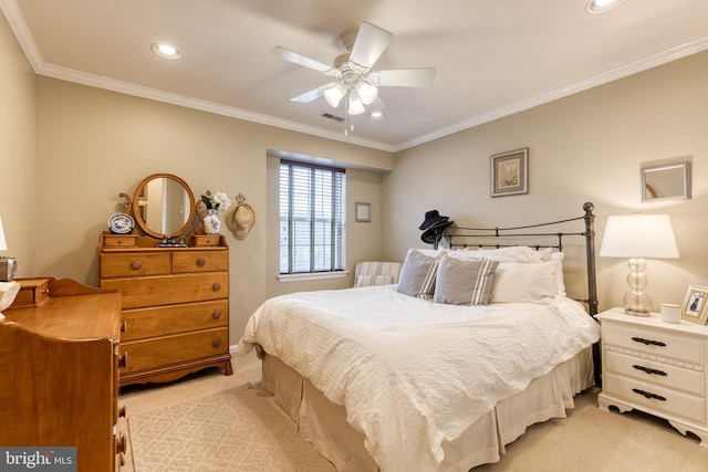 carpeted bedroom with ornamental molding and ceiling fan