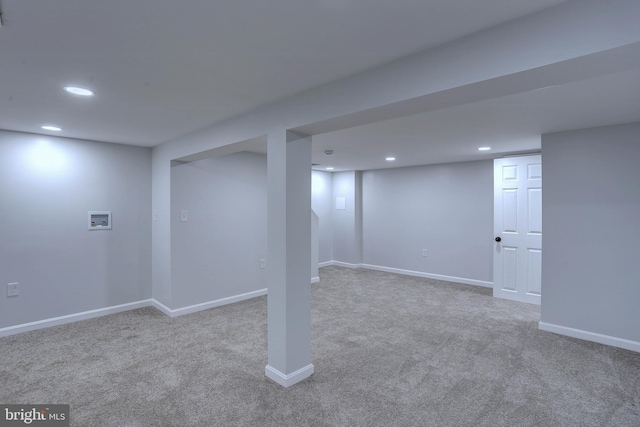 basement featuring light colored carpet