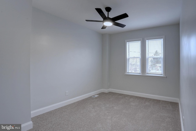 spare room with light carpet and ceiling fan