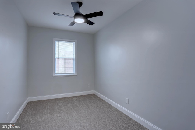 spare room with ceiling fan and carpet