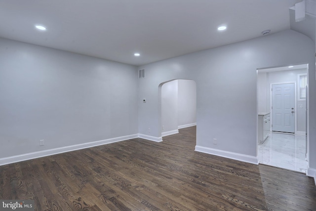 unfurnished room with dark wood-type flooring