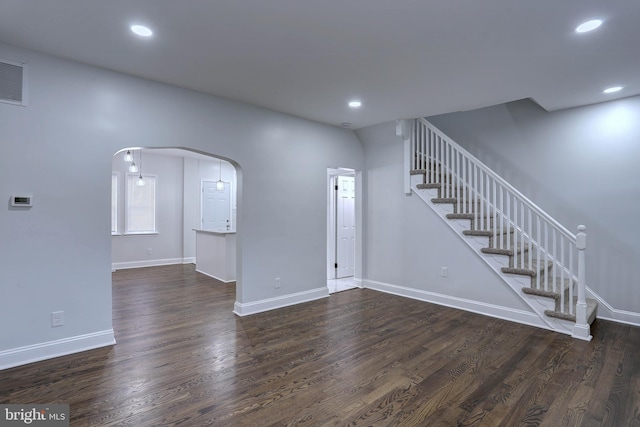 unfurnished living room featuring dark hardwood / wood-style floors