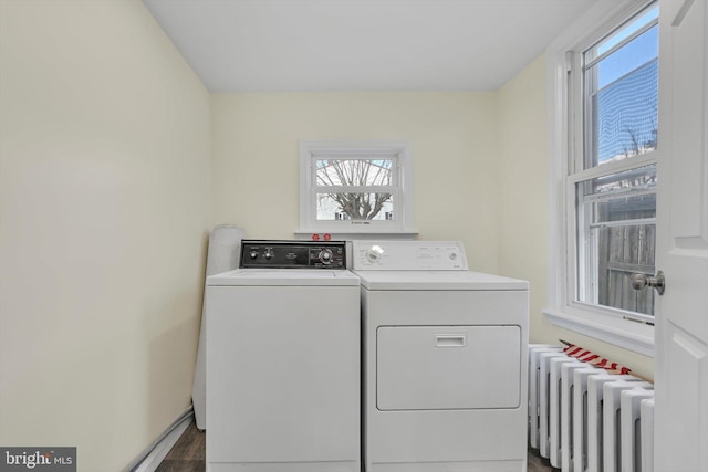 clothes washing area with radiator and washing machine and dryer