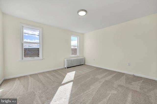 carpeted empty room with radiator