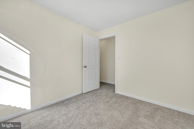 spare room with light carpet