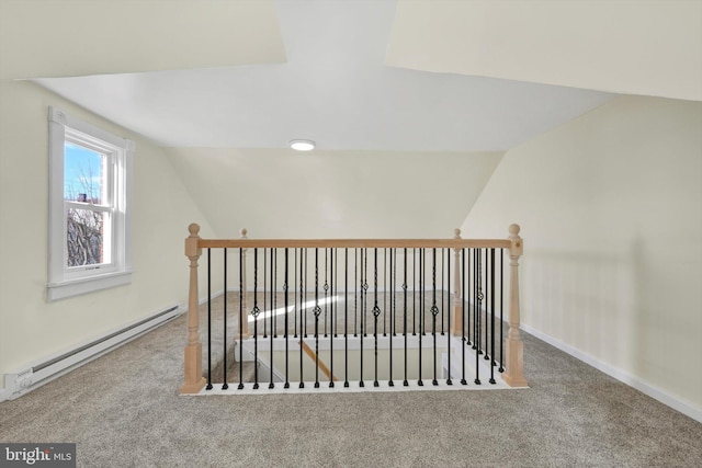 additional living space with carpet flooring, a baseboard radiator, and vaulted ceiling