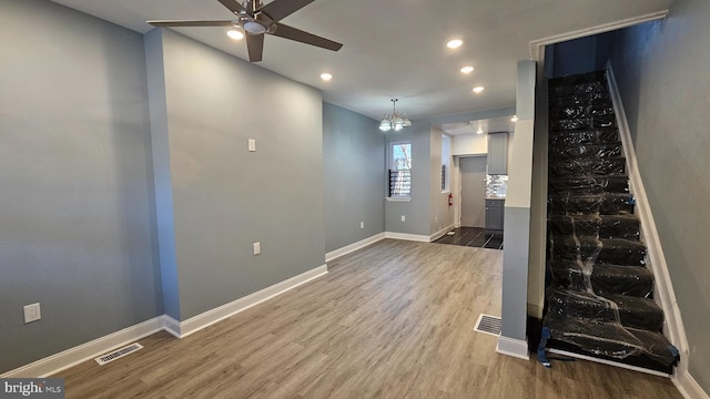 unfurnished living room featuring hardwood / wood-style flooring and ceiling fan