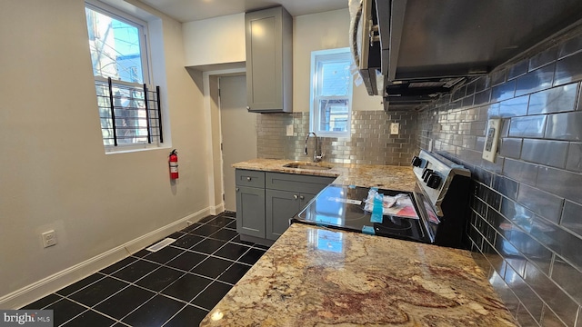 kitchen featuring gray cabinetry, sink, electric range, and light stone counters