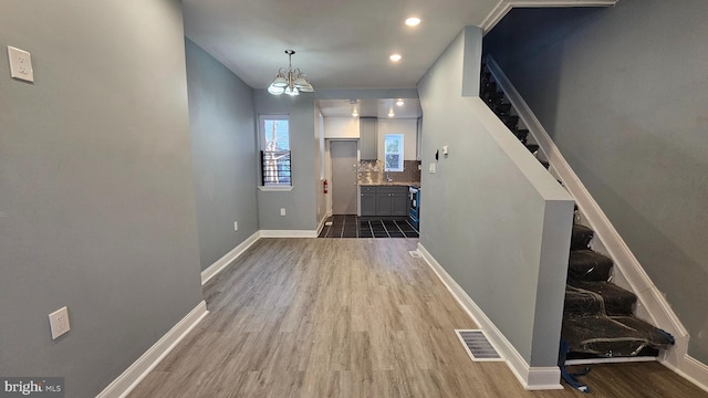 foyer with an inviting chandelier and dark hardwood / wood-style flooring