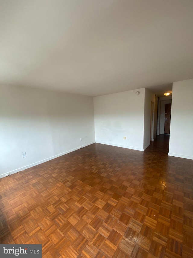 empty room featuring dark parquet flooring