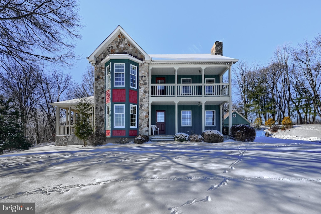 view of front of property with a balcony and covered porch