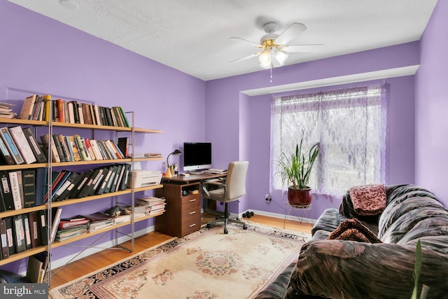 office area with ceiling fan, hardwood / wood-style floors, and a textured ceiling